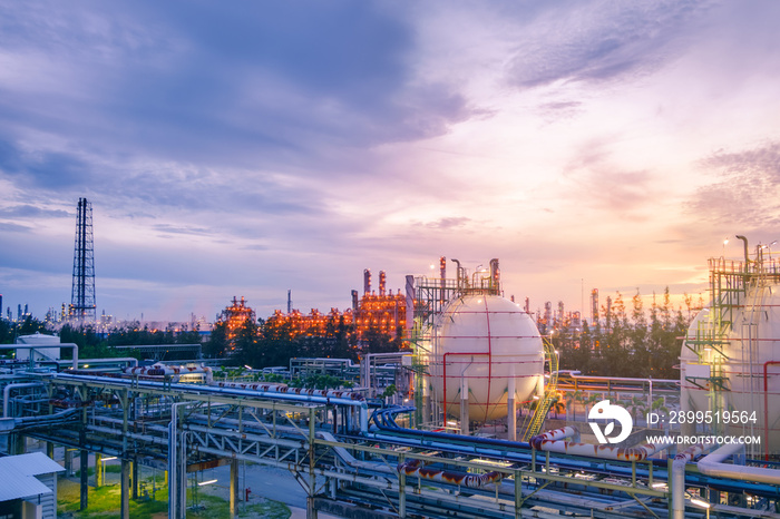 Gas storage sphere tanks and pipeline in oil and gas refinery industrial plant on sky sunset background