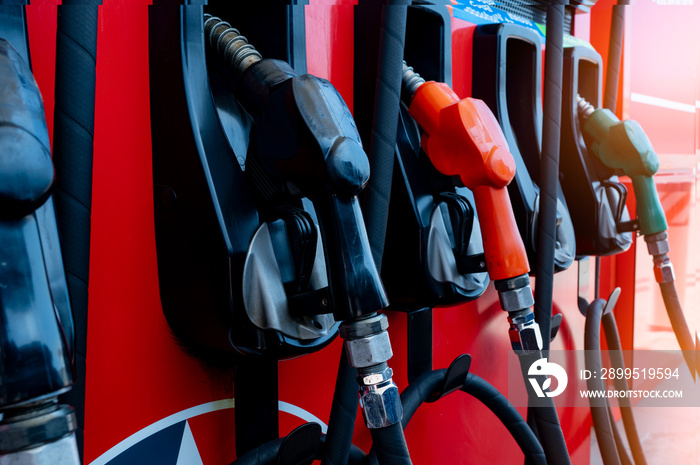 Gas pump nozzle in petrol station. Fuel nozzle in oil dispenser. Fuel dispenser machine. Refueling fill up with petrol gasoline and diesel. Petrol industry and service. Petroleum oil consumption.