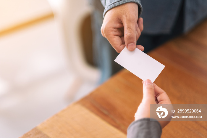 Two businessman holding and exchanging empty business card