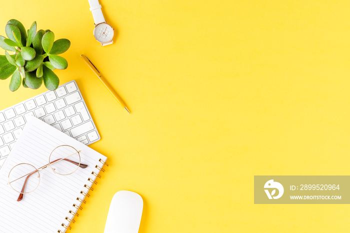 Overhead shot of office desktop with women’s accessories