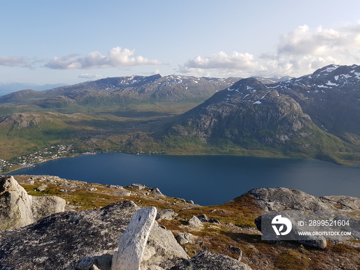 mighty sea and small settlement view from mountain top overlooking kvaloya island in northern Norway in summer