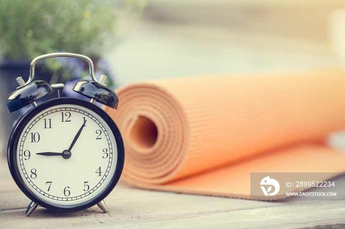 Time for exercising clock and yoga mat, outdoor