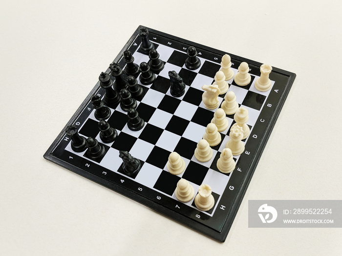 High angle view of travel chess set on a light background