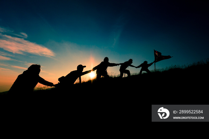 Leader handing Thailand Flag and climbers help A Team to conquer the summit in teamwork in a fantastic mountain landscape at sunset. Helping hand concept and international day of peace and teamwork.