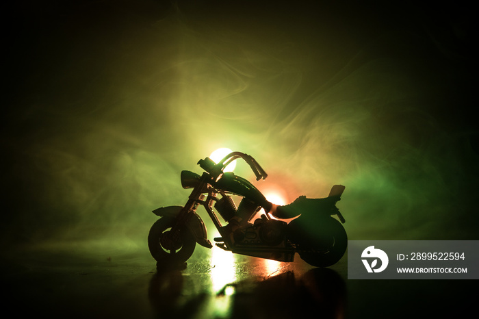 High power motorcycle chopper. Fog with backlights on background with man rider at night. Empty space