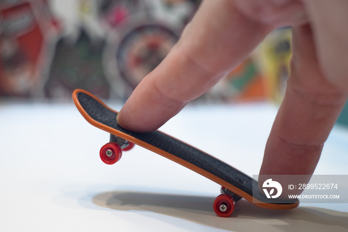 Finger skate. The skateboard is controlled by the fingers of the hand. Miniature board on wheels.