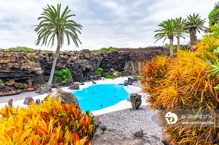 Beatiful exterior of the Jameos del Agua with pool and colorful trees, Lanzarote, Canary Islands, Spain