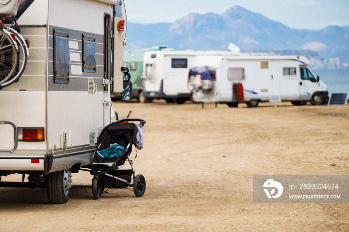 Baby stroller at caravan outdoors on beach.