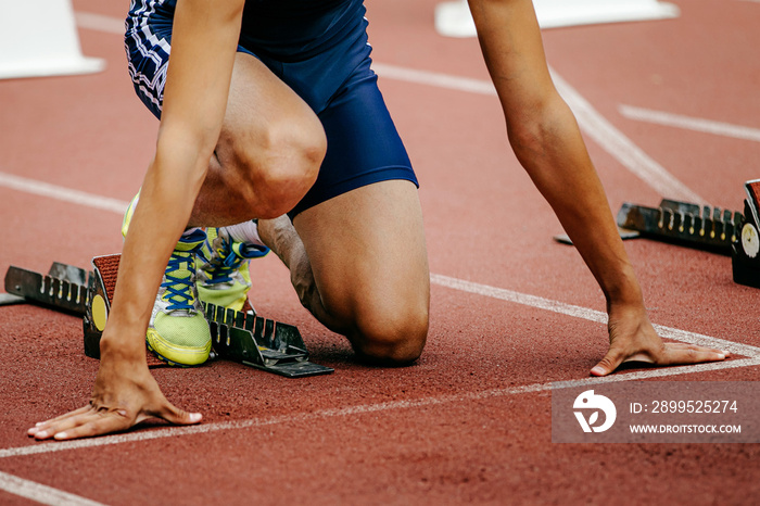 man athlete runner on starting line from starting blocks