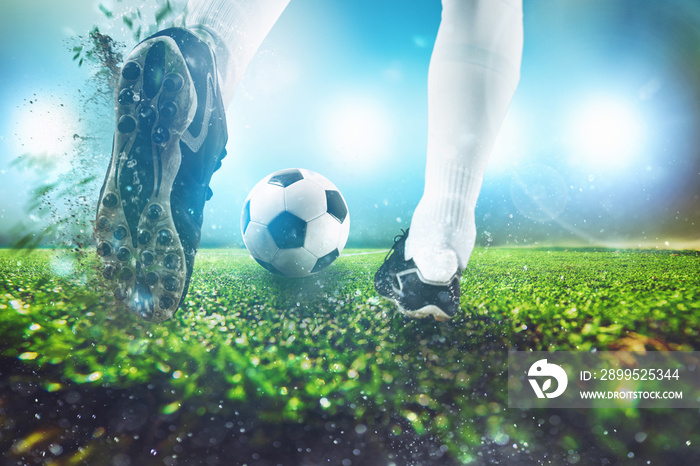 Football scene at night match with close up of a soccer shoe hitting the ball