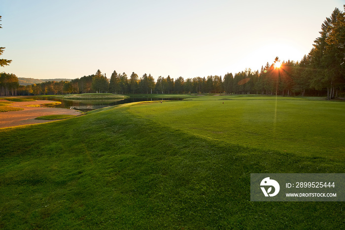 Sunset at the Golf Course - The sun sets on a putting green at the golf course in Autumn