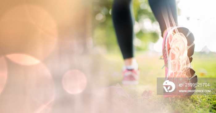 Composition of woman running in park with leg bones visible and spots of light