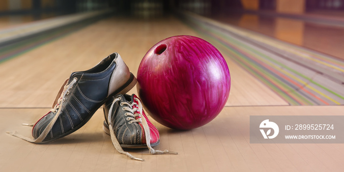 Ball and shoes on floor in bowling club