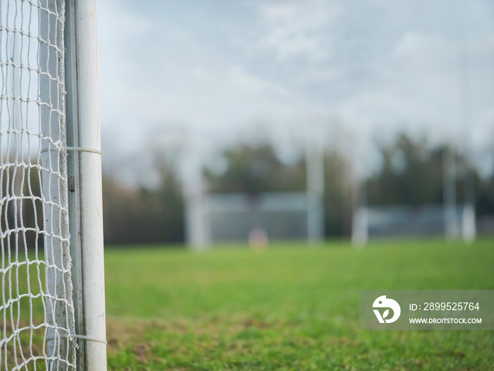 Side of goal post in focus, Two goal posts for Irish National sport camogie, hurling, rugby and football out of focus in the background.