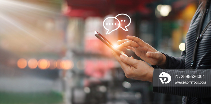 Woman using mobile smartphone on the street of shopping mall background.