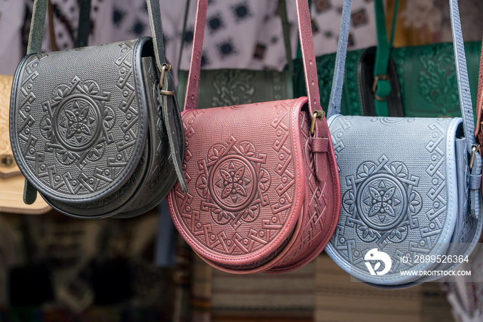 Female color embossed leather bags with carpathian pattern.