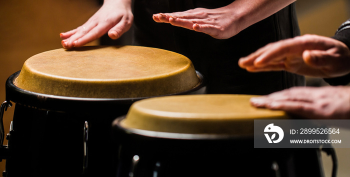 Drum. Hands of a musician playing on bongs. The musician plays the bongo. Close up of musician hand playing bongos drums. Afro Cuba, rum, drummer, fingers, hand, hit