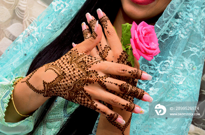 Henna Tattoo on Bride’s Hand.Moroccan wedding preparation henna party. Temperate white mehndi. Modern mehendi art...