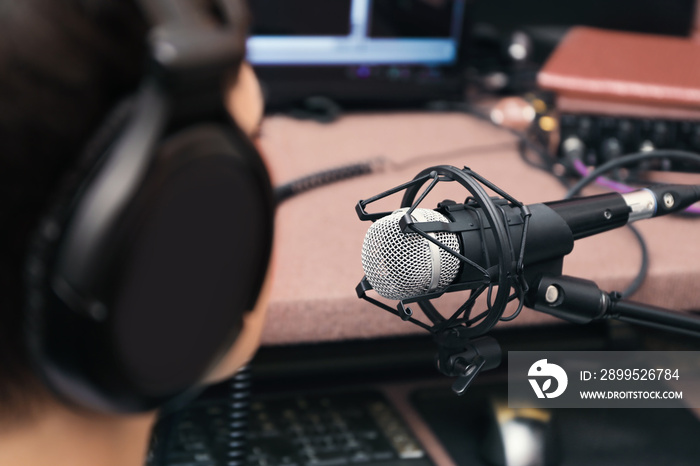 Young woman taking part in broadcast at modern radio station