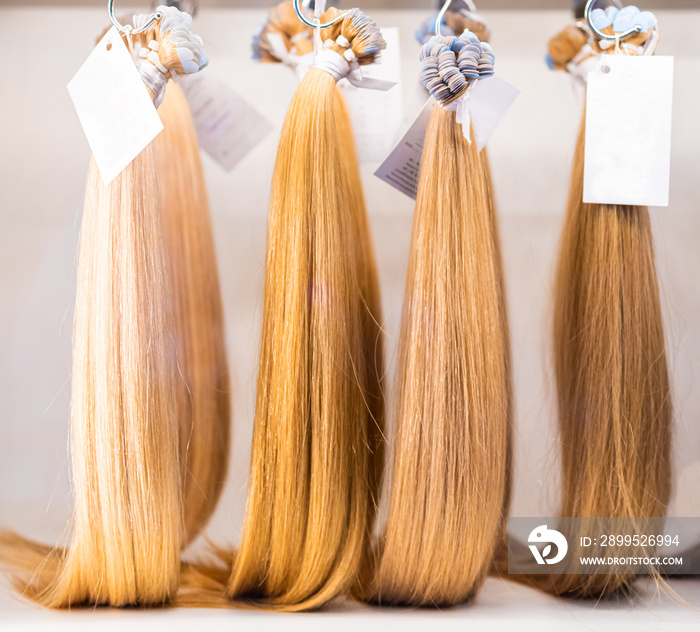 Exhibition of multicolored hair extensions in beauty salon