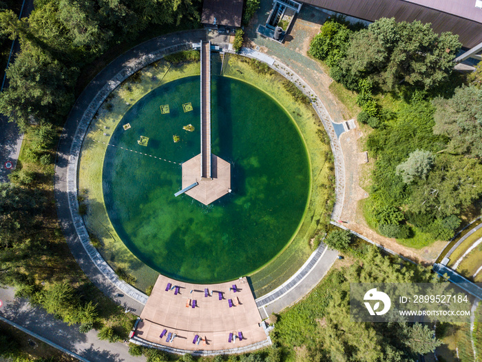 Aerial view of round swimming pool with chairs in Switzerland, Europe