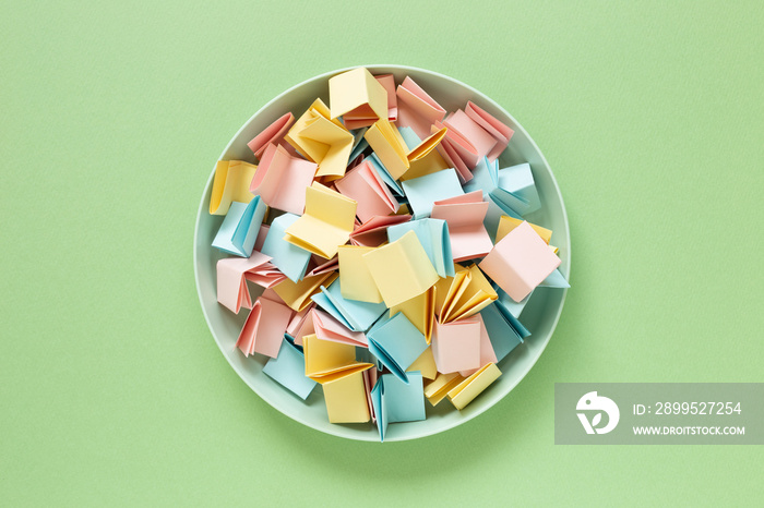 Draw lots. Folded colorful papers in bowl