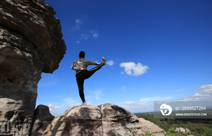 senior or Elder exercise Yoga on Big Rock on top of mountain