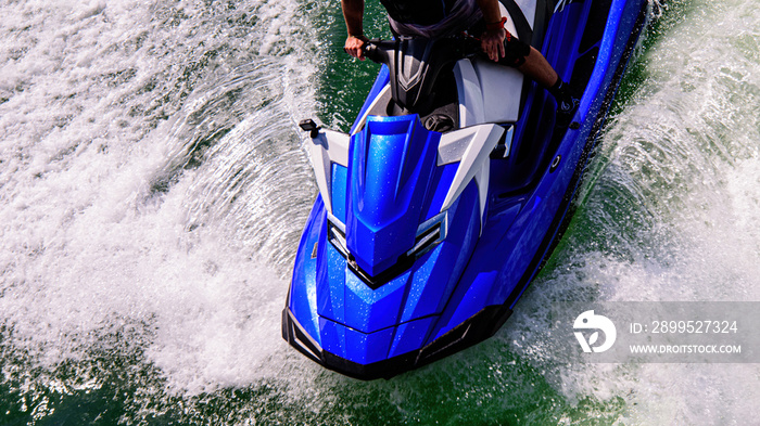 Speed on the ocean. Jetski. Beautiful sport on ocean waves. Tourist on a jet ski. Rest on the ocean. Summer vacation.