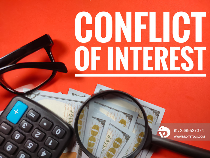 Business concept.Text CONFLICT OF INTEREST with magnifying glass, glasses,banknote and calculator on red background.