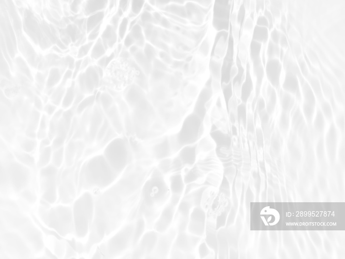 Defocus blurred transparent white colored clear calm water surface texture with splashes and bubbles. Trendy abstract nature background. Water waves in sunlight with copy space. White water shine