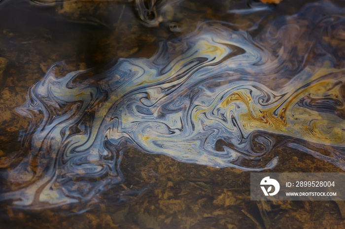 oil spills on puddle background, abstract gasoline nature pollution concept