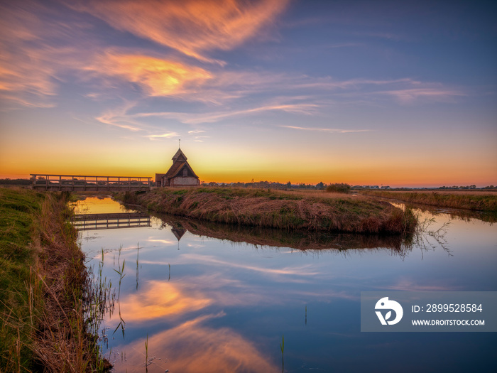 Autumnal clear evening sunset over St Thomas a Becket Church, Fairfield, in the Romney Marsh, Kent, UK