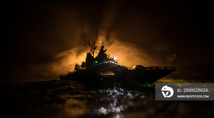 Silhouettes of a crowd standing at blurred military war ship on foggy background. Selective focus.