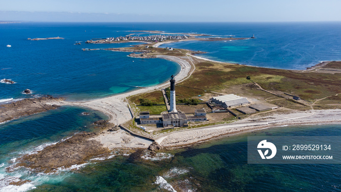 Great lighthouse of the Island of Sein in Brittany, France, in the Atlantic Ocean - Small flat isolated island with a black and white, tall and round lighthouse