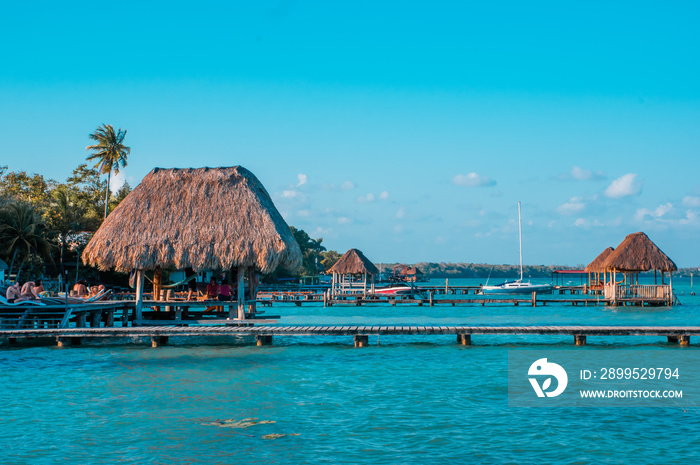 Color graded picture of a pier with clouds and blue water at the Laguna Bacalar, Chetumal, Quintana Roo, Mexico