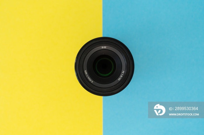 Camera lens in the center on the blue and yellow background