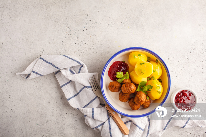 Swedish meatballs with boiled potatoes and cranberry sauce. Swedish  traditional food concept.