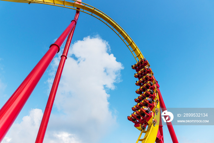 Rollercoaster Ride in theme park with blue sky