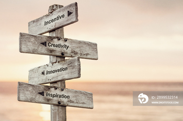 incentive creativity innovation inspiration text written on wooden signpost outdoors at the beach during sunset
