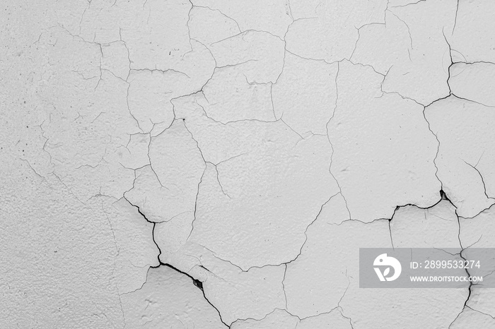 Cracked flaking white paint on the wall, background texture