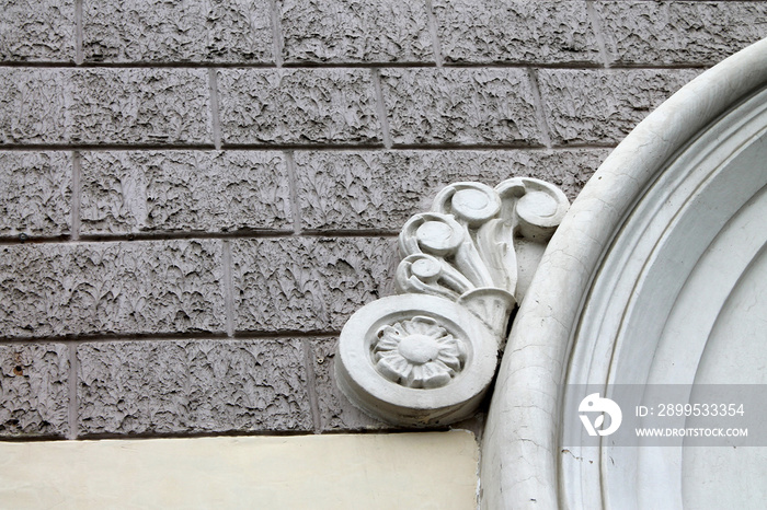 fragment of the old facade with stucco closeup