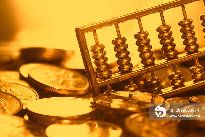 A gold abacus was placed on the background of the pile of COINS