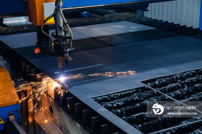 CNC plasma cutting metal iron material with sparks, industry background blue and orange color