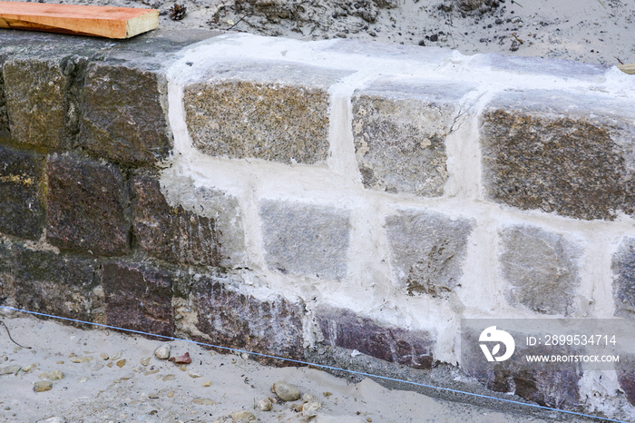 Cleaning of cobble square stone walls and restoration of seams