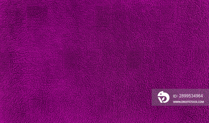 pink rug or towel texture for background. textile fabric consist of cotton fiber material. purple plush, fluffy, dry, soft and clean cloth background.