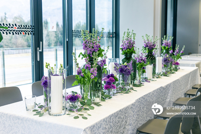 Purple and violet wedding flower arrangements, made out of carnations lisianthus and matthiola flowers.