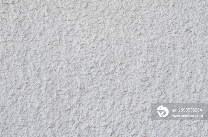 Background of a white stucco coated and painted exterior, rough cast of cement and concrete wall texture, decorative coating