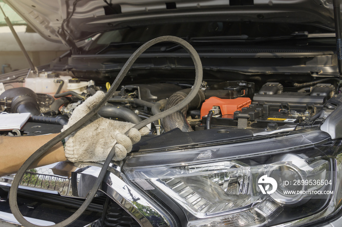 Car mechanic replacing timing belt