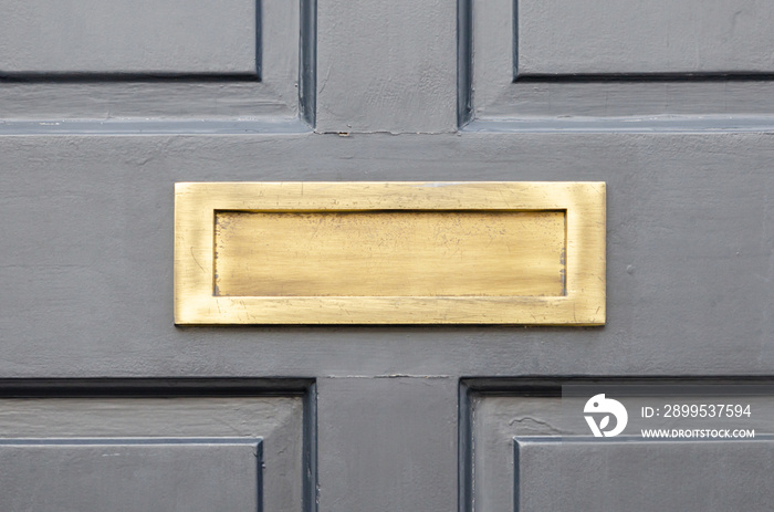 Old letterbox in the door, traditional way of delivering letters to the house, old mailbox