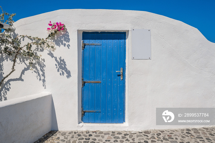 Blue wooden door and wall backgrounds of traditional Greek Island buildings